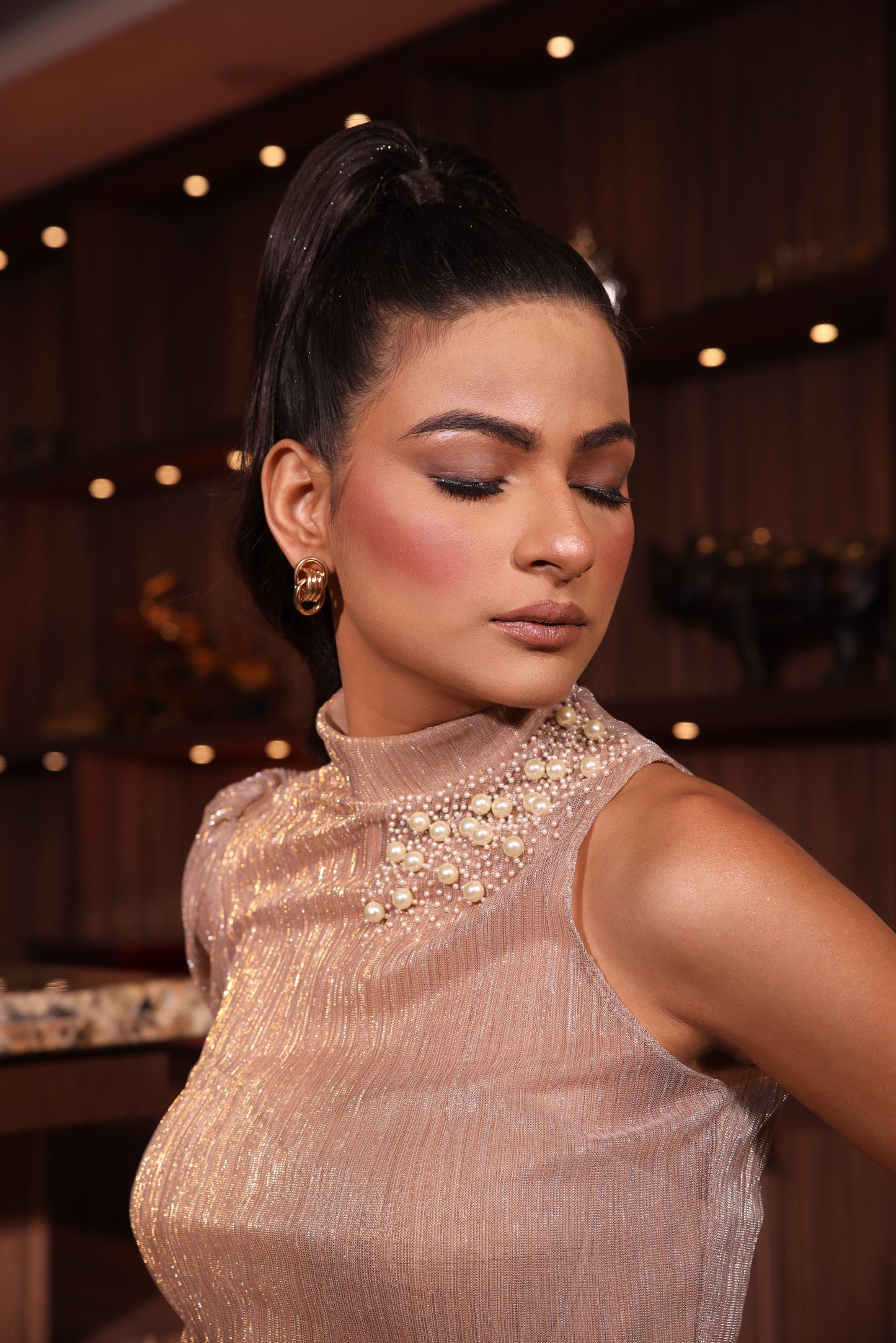 Pearls-studded single sleeve shimmer top paired with shimmer trousers